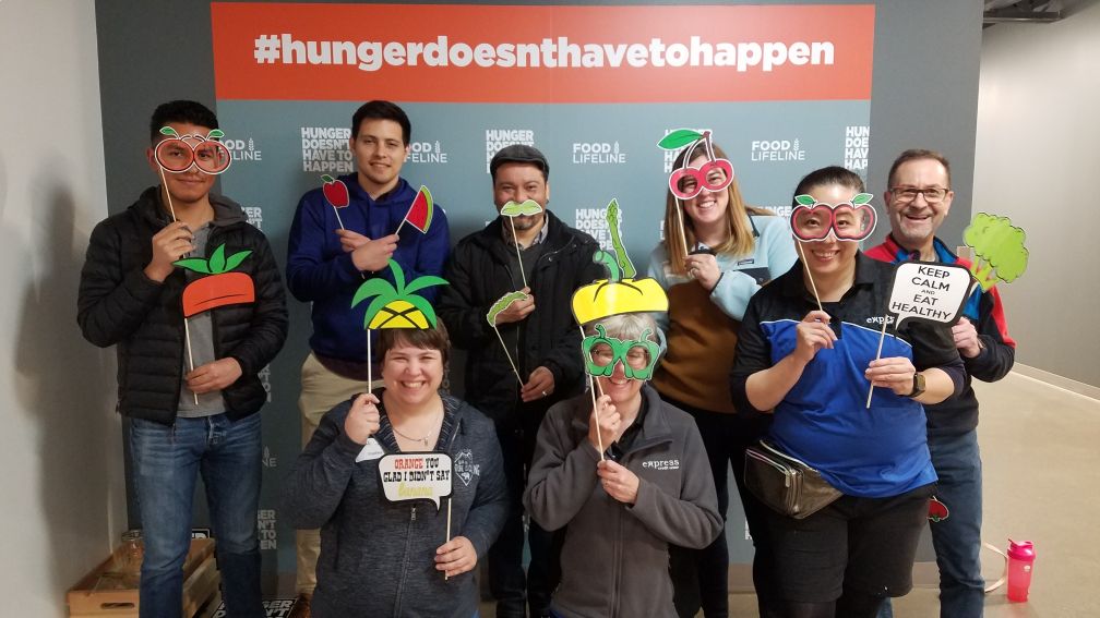 Express CU staff showing their support for #hungerdoesnthavetohappen by wearing funny masks and holding props shaped like food